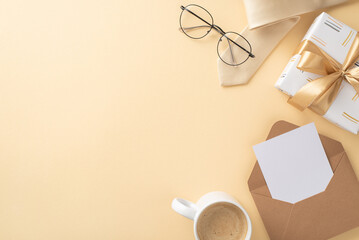 Treat Dad to an elegant Father's Day with top view of beige necktie, glasses, giftbox with golden bow, envelope with letter, coffee cup, on a beige background with an empty space for text or advert