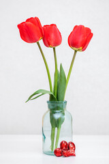 Beautiful tulips in a vase for Mother's Day on a light background