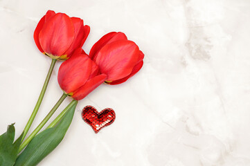 Red tulips on a light background and a red heart.