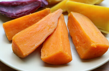 Fototapeta na wymiar Plate of three different color steamed sweet potatoes, a good source of healthy carbs
