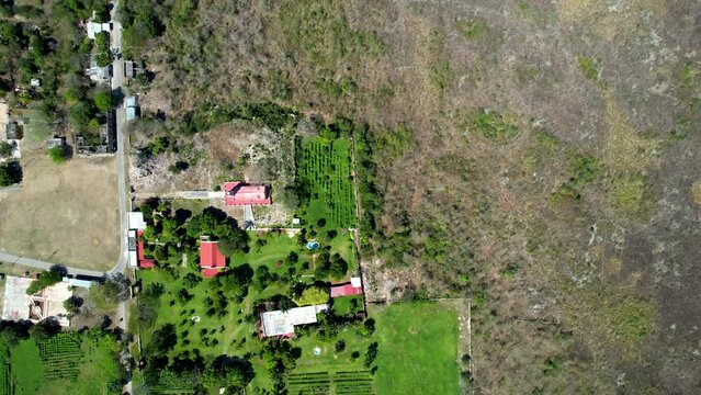 aerial drone shot of green grass hacienda ake in yucatan
