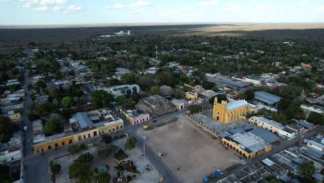 orbital drone shot of the town of acanceh and mayan ruins at yucatan mexico