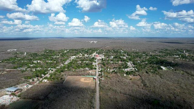 backwards drone shot of tahmek town during heavy drought in yucatan mexico