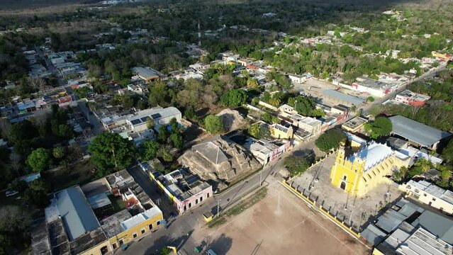 aerial shot of main plaza of acanceh with mayan ruins and church at yucatan mexico
