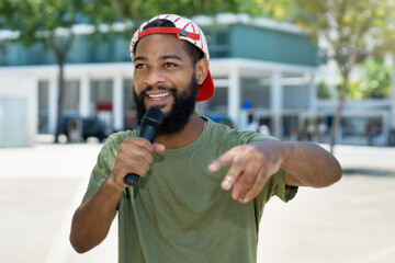 Famous rapper singing outdoor in the city - obrazy, fototapety, plakaty