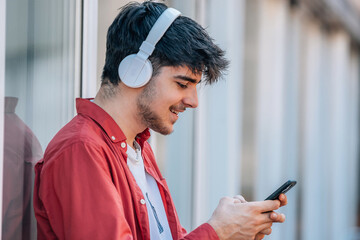 young male with mobile phone and headphones