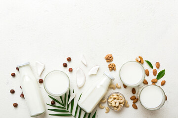 Set or collection of various vegan milk almond, coconut, cashew, on table background. Vegan plant based milk and ingredients, top view