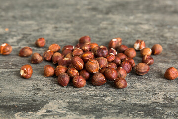 Wooden bowl full of hazelnuts on table background. Healthy eating concept. Super foods