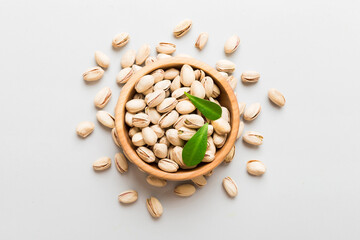 Fresh healthy Pistachios in bowl on colored table background. Top view Healthy eating concept. Super foods
