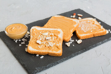 Peanut butter sandwiches or toasts on light table background.Breakfast. Vegetarian food. American cuisine top view vith copy space
