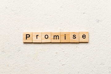 Promise word written on wood block. Promise text on cement table for your desing, concept