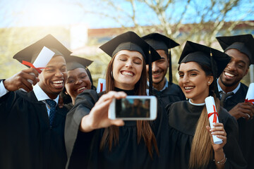 Real world, were ready for you. a group of students taking selfies with a mobile phone on...