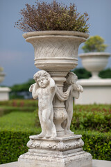 kid statue in the garden as a plant pot