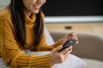 Fototapeta premium Happy smart young woman Asian using smartphone for shopping, mobile shopping, beautiful woman doing online purchases, shopping online