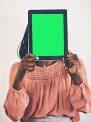 Its my essential business tool. a businesswoman holding a digital tablet with a green screen.