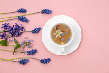 Tea Time: Relaxing with herbal tea with healing properties. Drink with natural herbs. Floral tea arrangement. Nature's remedy aromatic herbal tea with healing herbs and flowers top view vertical