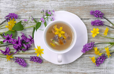 Tea Time: Relaxing with herbal tea with healing properties. Drink with natural herbs. Floral tea arrangement. Nature's remedy aromatic herbal tea with healing herbs and flowers top view vertical