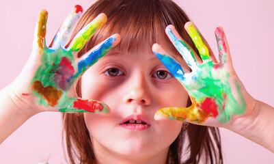 Beautiful young girl with colorful painted hands. Art and creativity concept