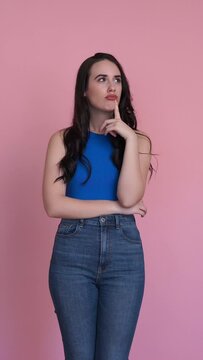 Woman showing doubt in a studio shot. Vertical video.
