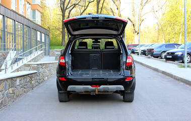 Modern SUV open trunk. Modern black car with open empty trunk. Modern wagon black car open trunk....