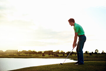 The master of his club is master of his mind. a young man spending the day on a golf course.