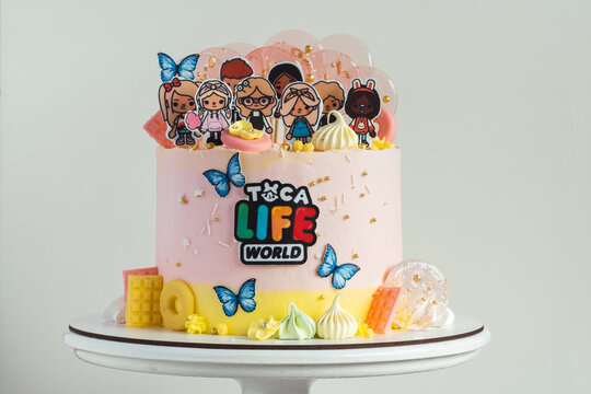 KYIV, UKRAINE - April 01: Birthday cake for a little fan of Toca Life World video game. Pink cake for a girl on the white background