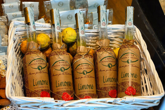 Palermo, Sicily, Italy, Europe, Nonna Vincenza Limone liqueur bottles in basket - Rosolio or Limoncello liquers are often offered to house guests as a sign of good luck 