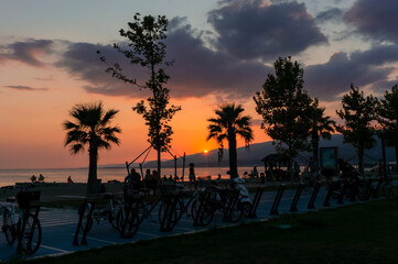 Obraz premium sunset at the beach and people.
