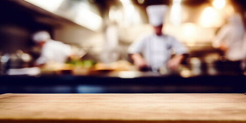 Empty Wood table top with Chef cooking in restaurant kitchen blurred defocused background