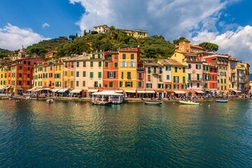 Fototapeta na wymiar Colorful houses in the port of Portofino village, luxury tourist resort in Genoa Province, Liguria, Italy, Europe. Mediterranean sea (Ligurian sea).