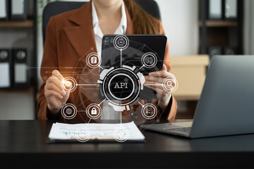woman using laptop, tablet and smartphone with virtual screen API icon Software development tool. API Application Programming Interface, modern technology and networking concept.