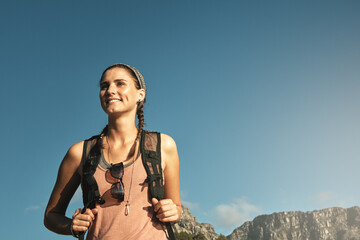 Live with a little adventure. a young woman out on a hike through the mountains.