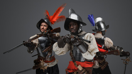 Fototapeta premium Studio shot of conquistadors dressed in steel cuirasses and plumed helmet.