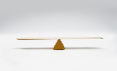 Empty seesaw balancing on white background..