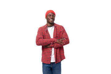 successful confident young american man in red cap and plaid shirt shows calm on white background with copy space