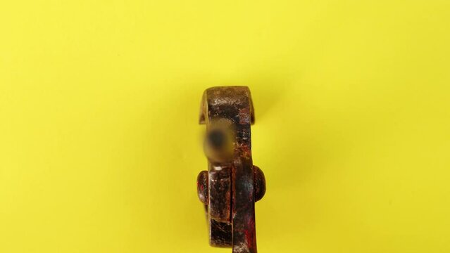 Motion over metal nipping pliers covered with brown rust