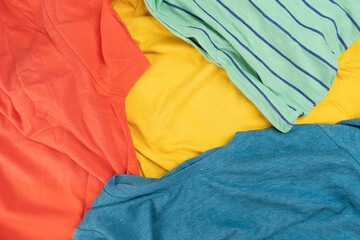 Pile of mixed dirty colorful clothes ready for washing ,house cleaning and housework background...