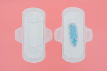 Sanitary pad compare with full amount of blue blood.
