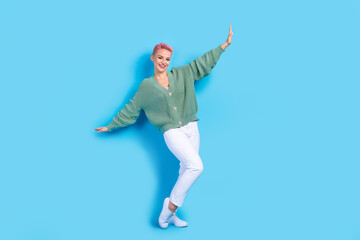 Fototapeta na wymiar Full length body cadre of careless chilling weekend funky lady dance wear white pants green shirt isolated on blue color background
