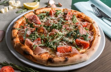 Tasty pizza with  prosciutto and  arugula . Italian pizza