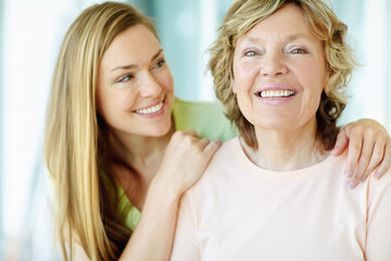 Everyday is mothers day for her. Portrait of a senior woman smiling and recieving some affection from her pretty daughter.