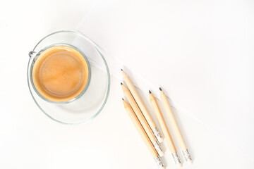 Notepad, pencils and cup of coffee