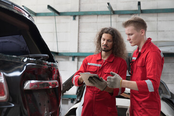 Group of male car mechanic repair rear window of car in auto repair shop. Team of technician checking broken damaged of rear window of car in garage workshop