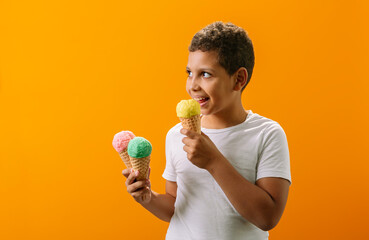 inspired by the anticipation of sweet things, a Black boy stands with ice cream cones in waffle...