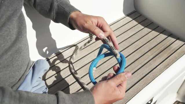 Tying a water knot. Close-up. Two-rope knot. Useful and strong knot. Guide from a sailor. 