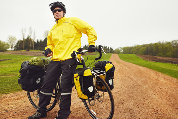 Obraz premium Cycling is an all-weather sport. a male cyclist enjoying a bike ride on a wet winters morning.