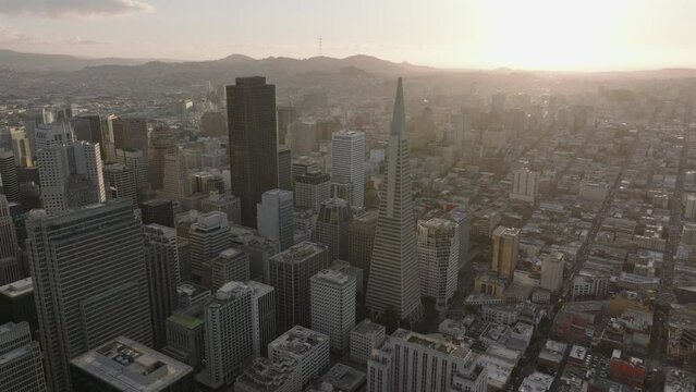 Aerial panoramic view of metropolis at sunset. Famous Transamerica Pyramid surrounded by high rise office or apartment downtown buildings.