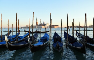 Fototapeta premium Gondolas standing on the pier in the Italian city of Venice