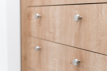 wood chest of drawers with knobs in living room