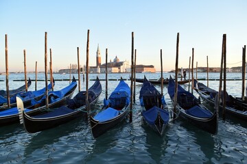 Fototapeta premium Gondolas standing on the pier in the Italian city of Venice